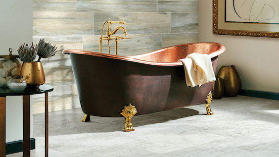 elegant grey tile flooring in a bathroom with a copper tub 
